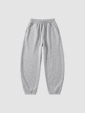 Y2K Studio grey barrel leg sweatpants with a high elastic waist, drawstring, and deep side pockets.