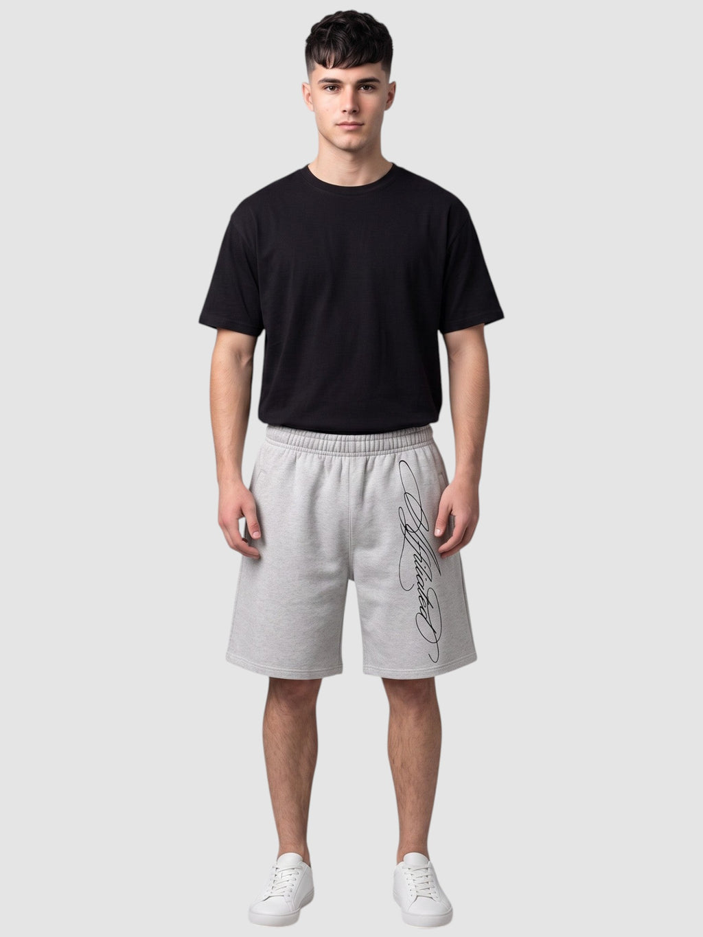 Y2K Studio grey fleece shorts with black cursive calligraphy print, featuring an elastic waist and relaxed fit.