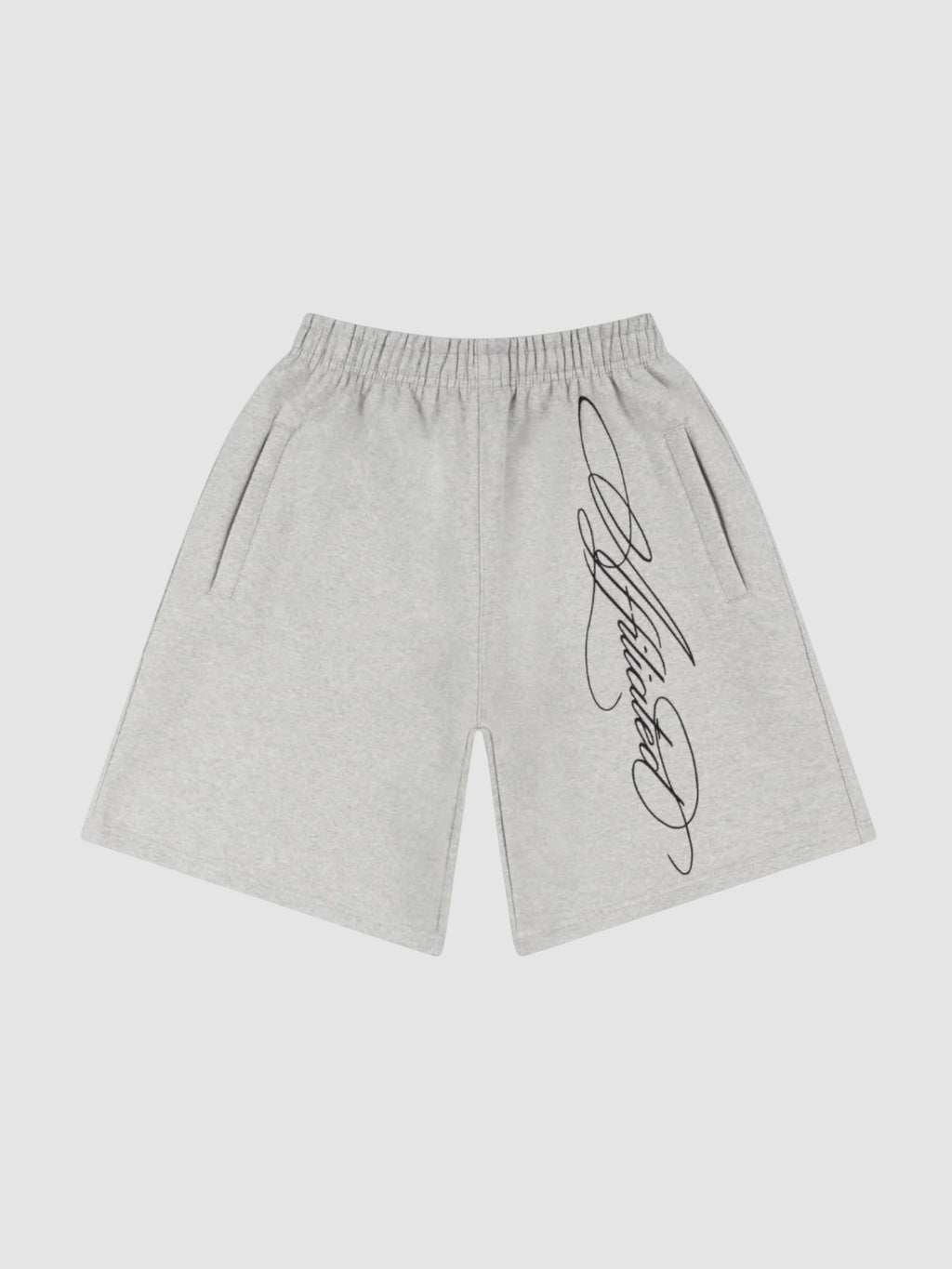 Y2K Studio grey fleece shorts with black cursive calligraphy print, elastic waist, and side pockets.