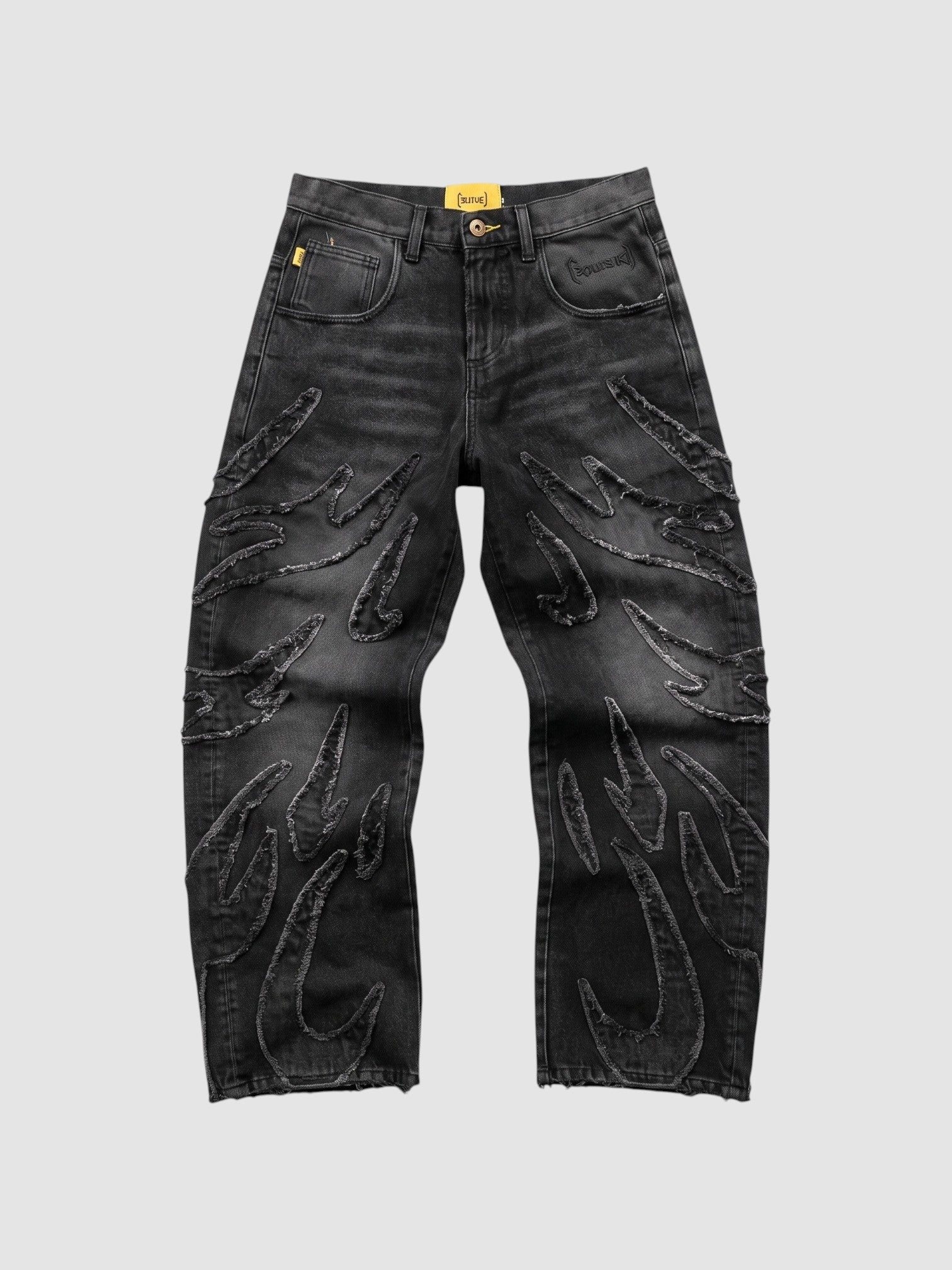 Y2K Studio baggy grey denim jeans featuring raw-edge flame appliqués and a wide-leg fit.