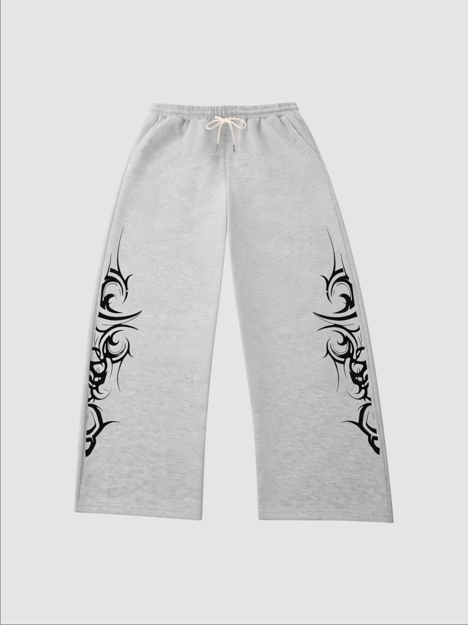 Y2K Studio grey heather wide-leg joggers featuring black tribal graphic prints on the sides and an elastic waistband.