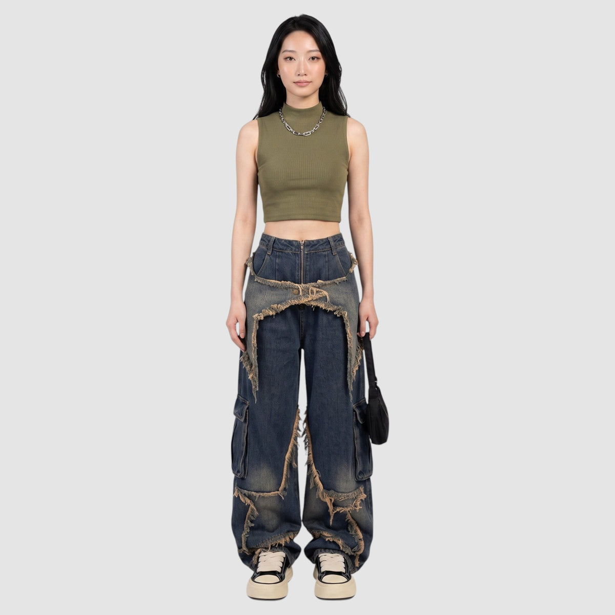 Y2K STUDIO high-waisted indigo cargo jeans with frayed denim fringe details and side pockets on a model