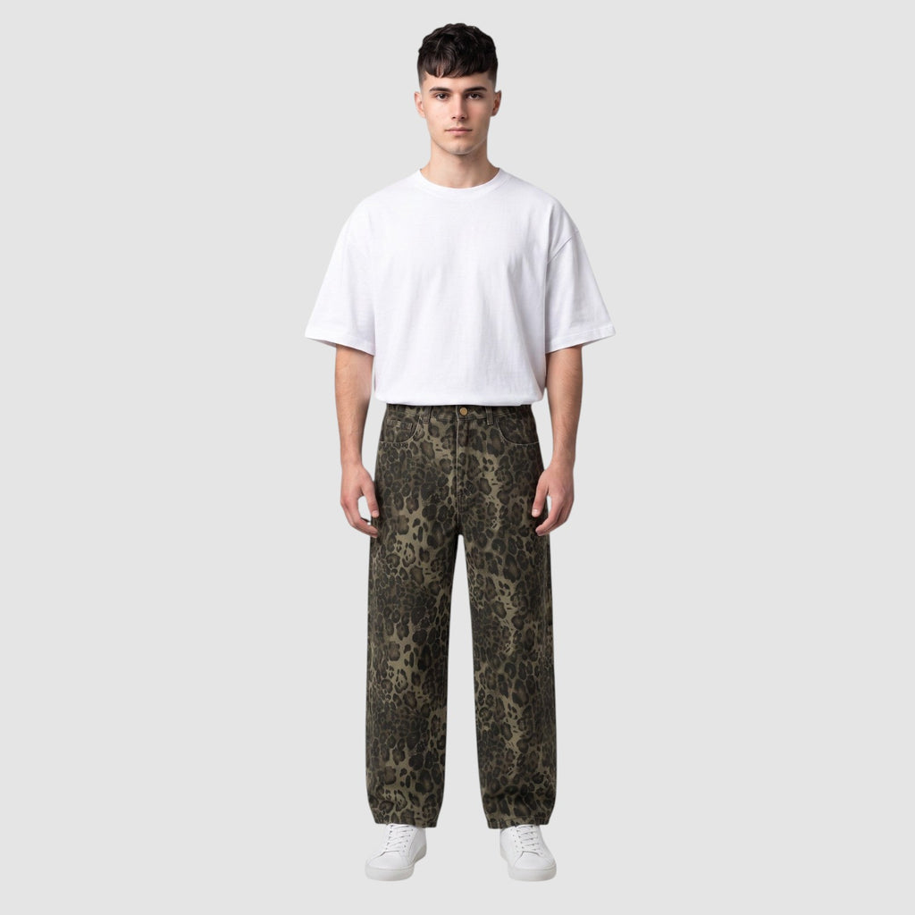 Y2K Studio baggy leopard print denim jeans with a wide leg fit worn by a male model with a white t-shirt
