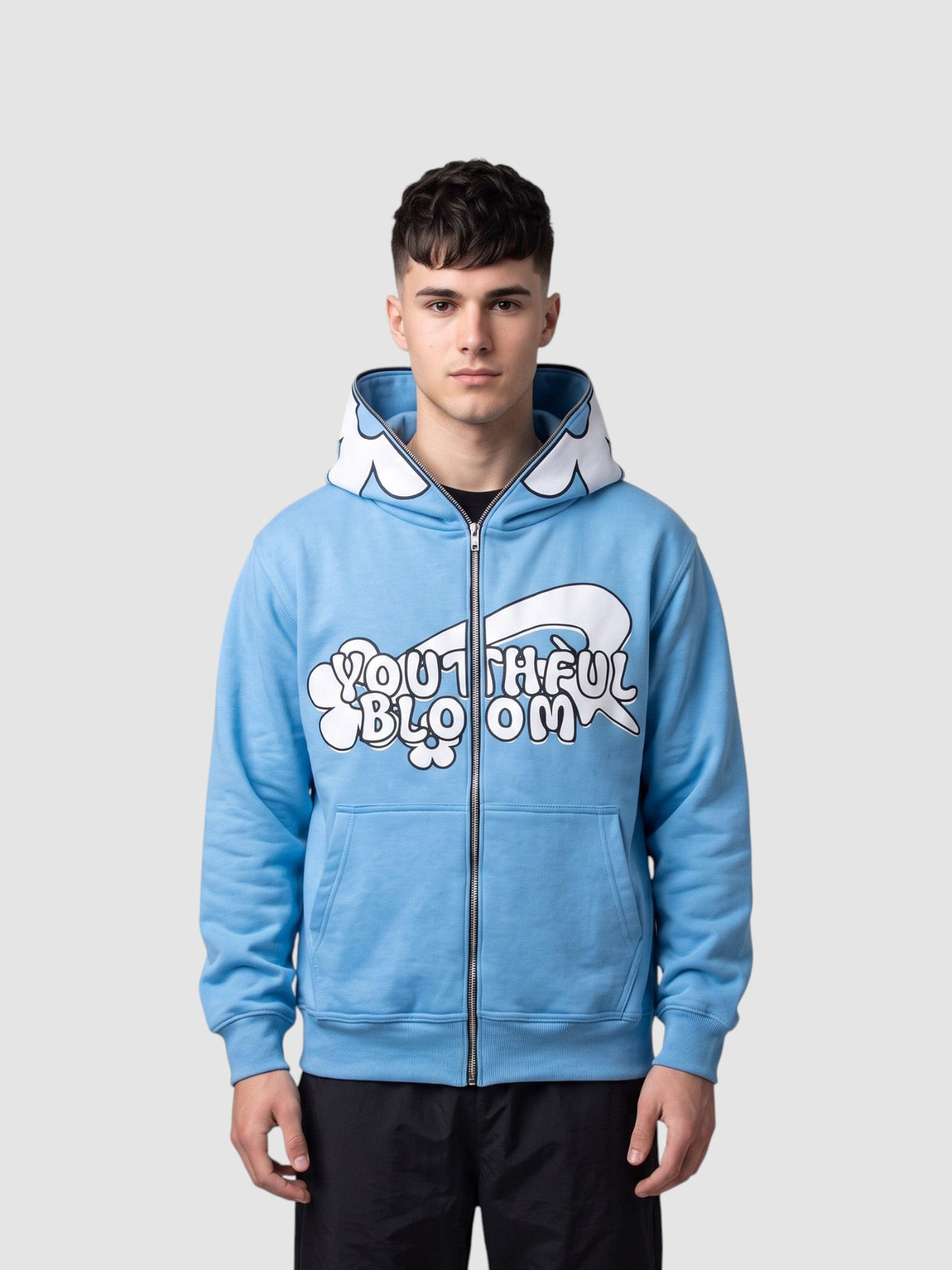 Y2K Studio light blue zip-up hoodie featuring a large white flower on the hood and bubble lettering graphic on front