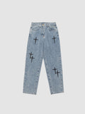 Y2K Studio light wash denim jeans for men featuring black embroidered cross patterns and a relaxed straight fit.