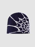 Y2K Studio navy blue beanie with a white spider web graphic pattern in a lightweight polyester knit fabric.