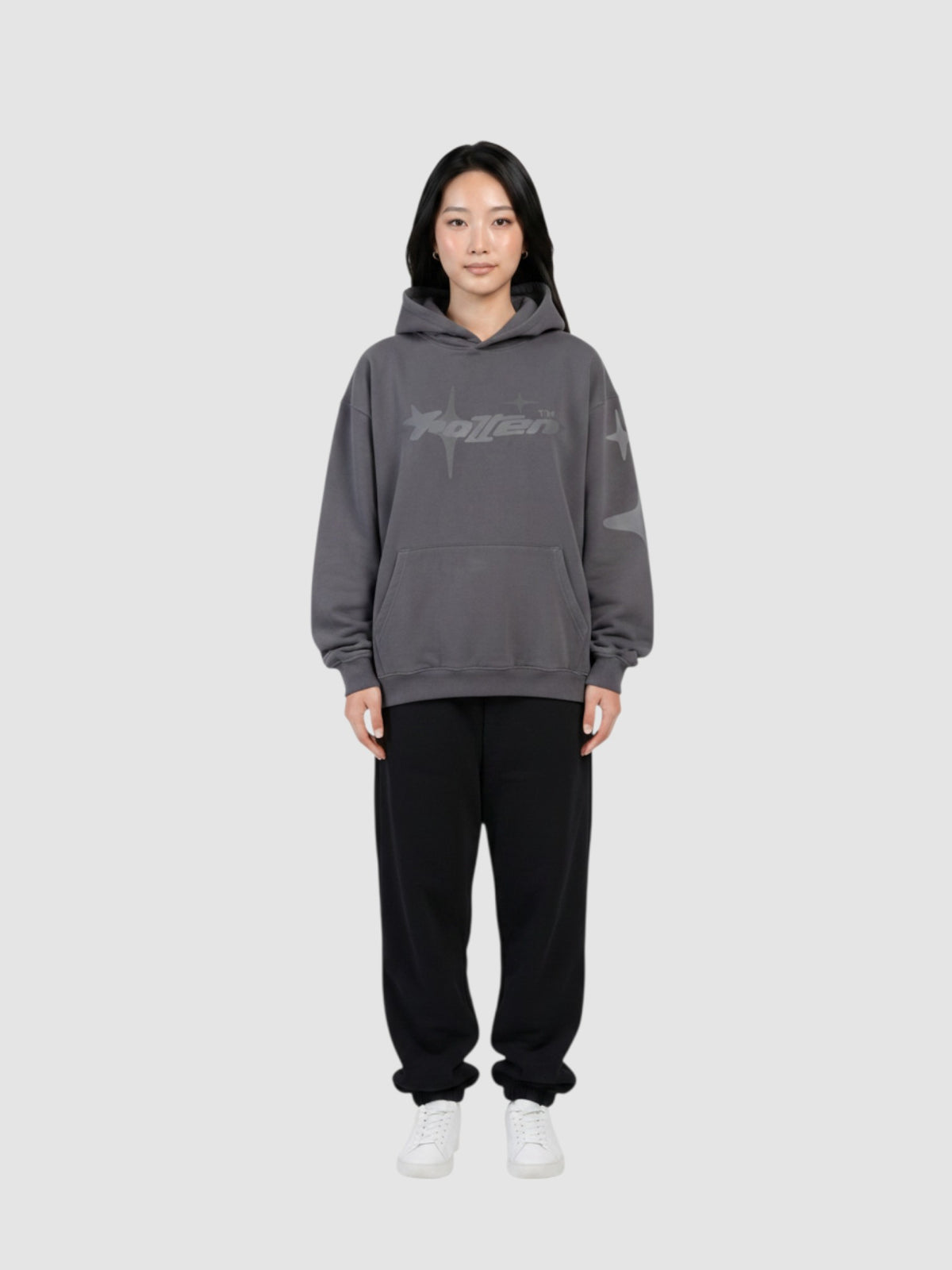 Y2K Studio oversized grey hoodie with star graphic print, worn by a model with black sweatpants and white sneakers.