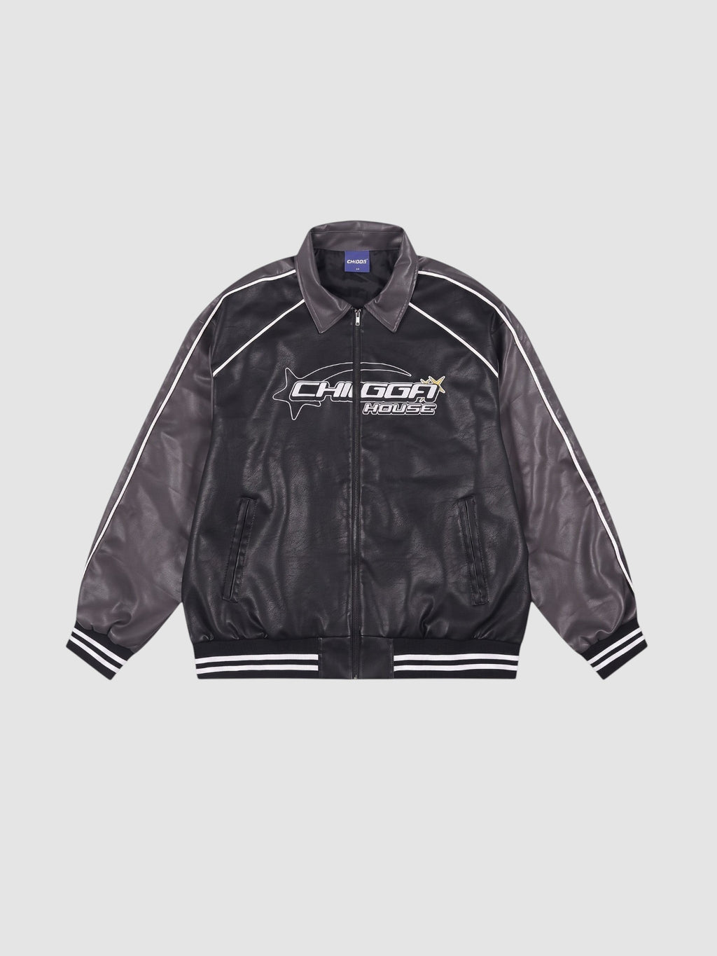 Y2K Studio oversized motorcycle jacket in black and charcoal with white piping, graphic print, and ribbed cuffs.