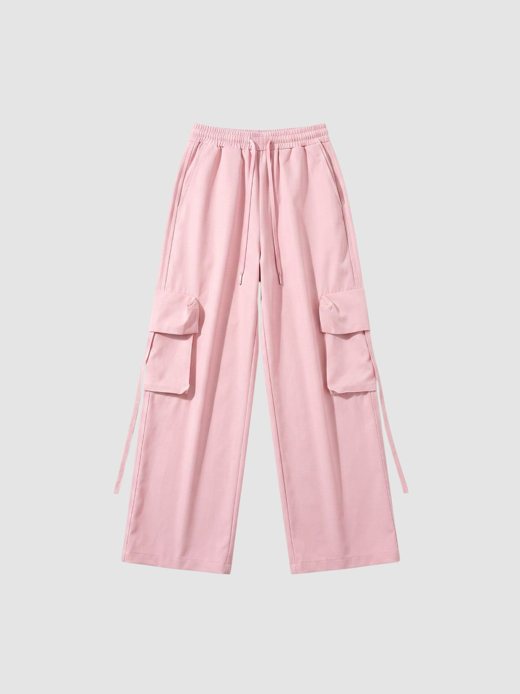 Y2K Studio powder pink parachute cargo pants with wide legs, elastic waist, drawstring, and side flap pockets.
