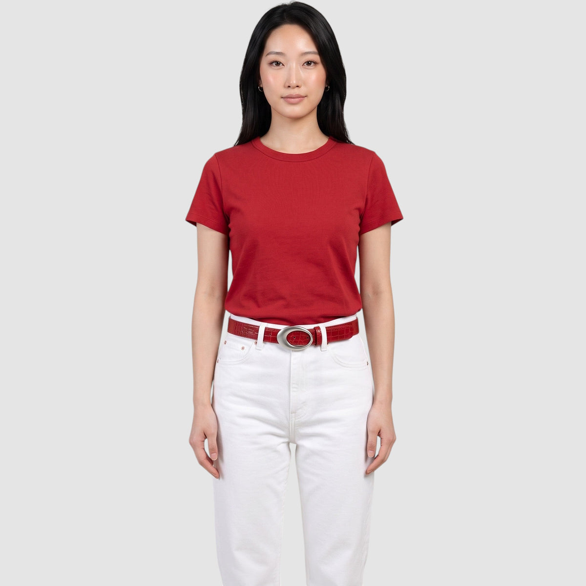 Y2K STUDIO red faux crocodile leather belt with a silver oval buckle worn by a model in a red t-shirt and white jeans