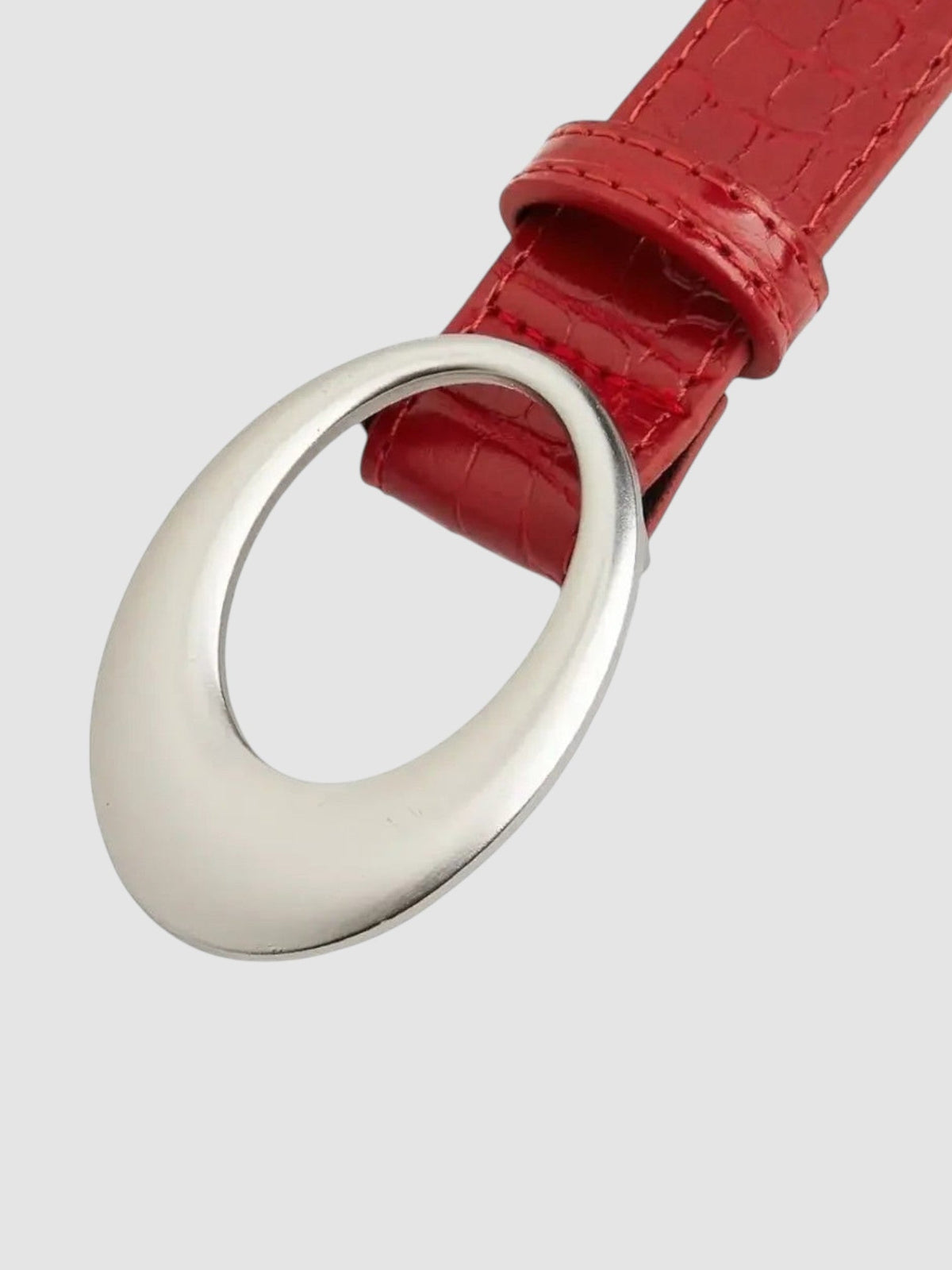 Y2K Studio red faux crocodile leather belt with a large polished silver oval buckle