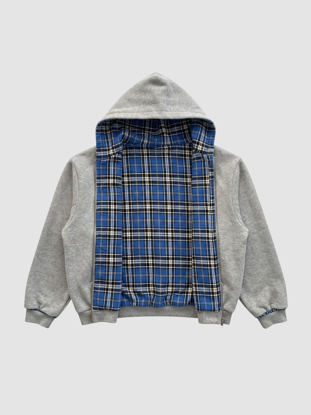 Y2K STUDIO reversible zip-up hoodie featuring a grey cotton fleece exterior and a blue tartan plaid interior lining.