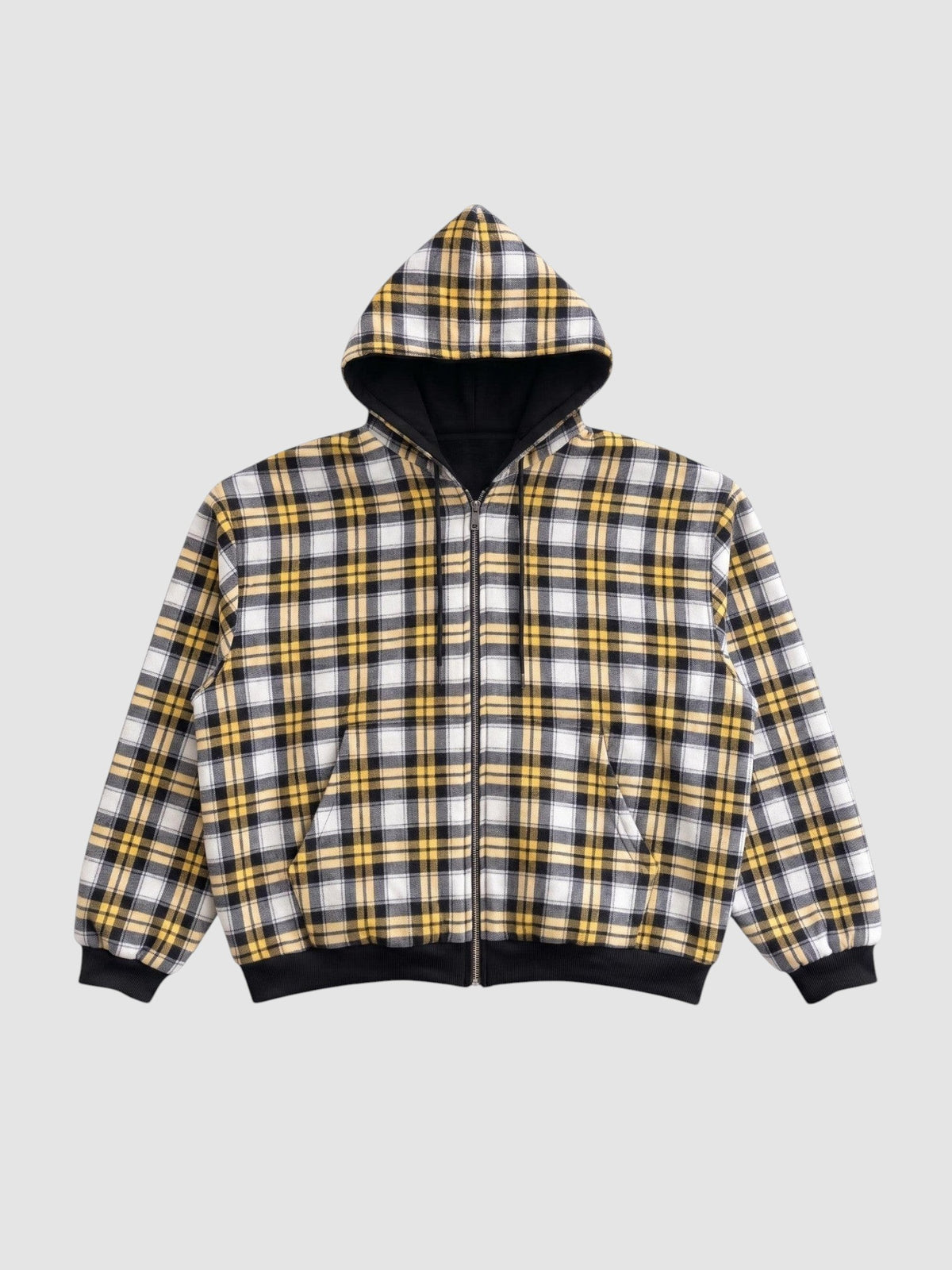 Y2K STUDIO reversible zip-up hoodie featuring a yellow, white, and black plaid pattern with black ribbed cuffs.