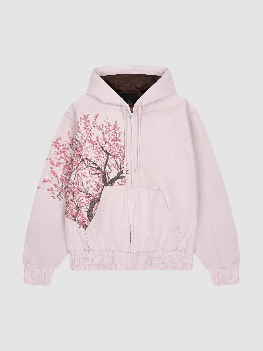Y2K Studio Sakura zip-up hoodie in faded powder pink cotton with an asymmetrical cherry blossom print and dark lining.
