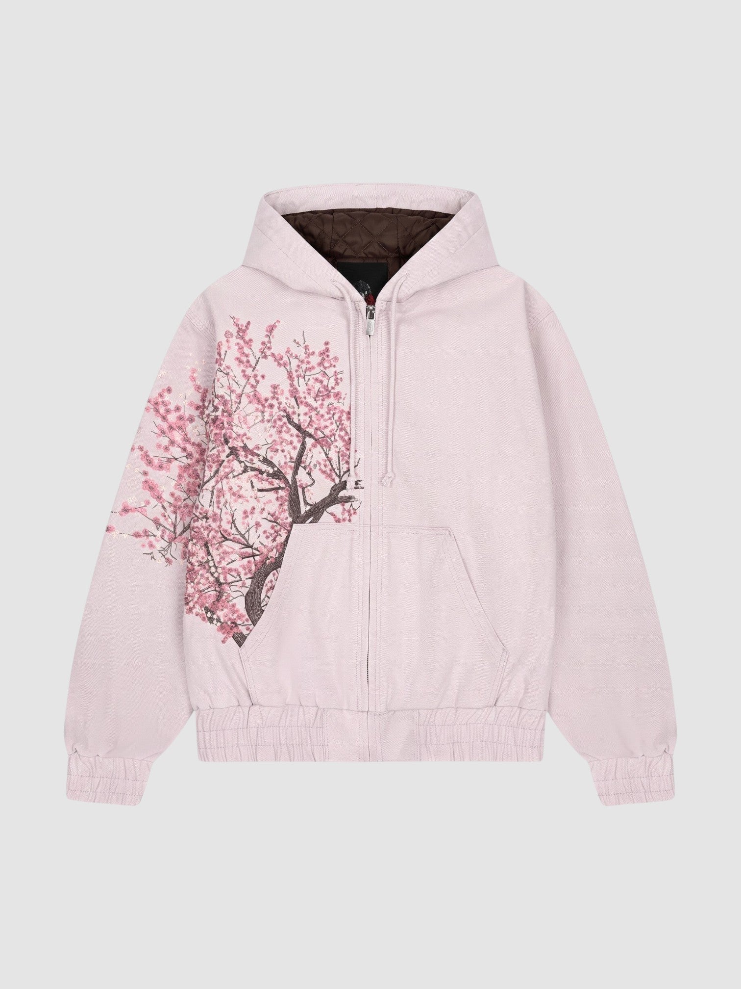 Y2K Studio Sakura zip-up hoodie in faded powder pink cotton with an asymmetrical cherry blossom print and dark lining.