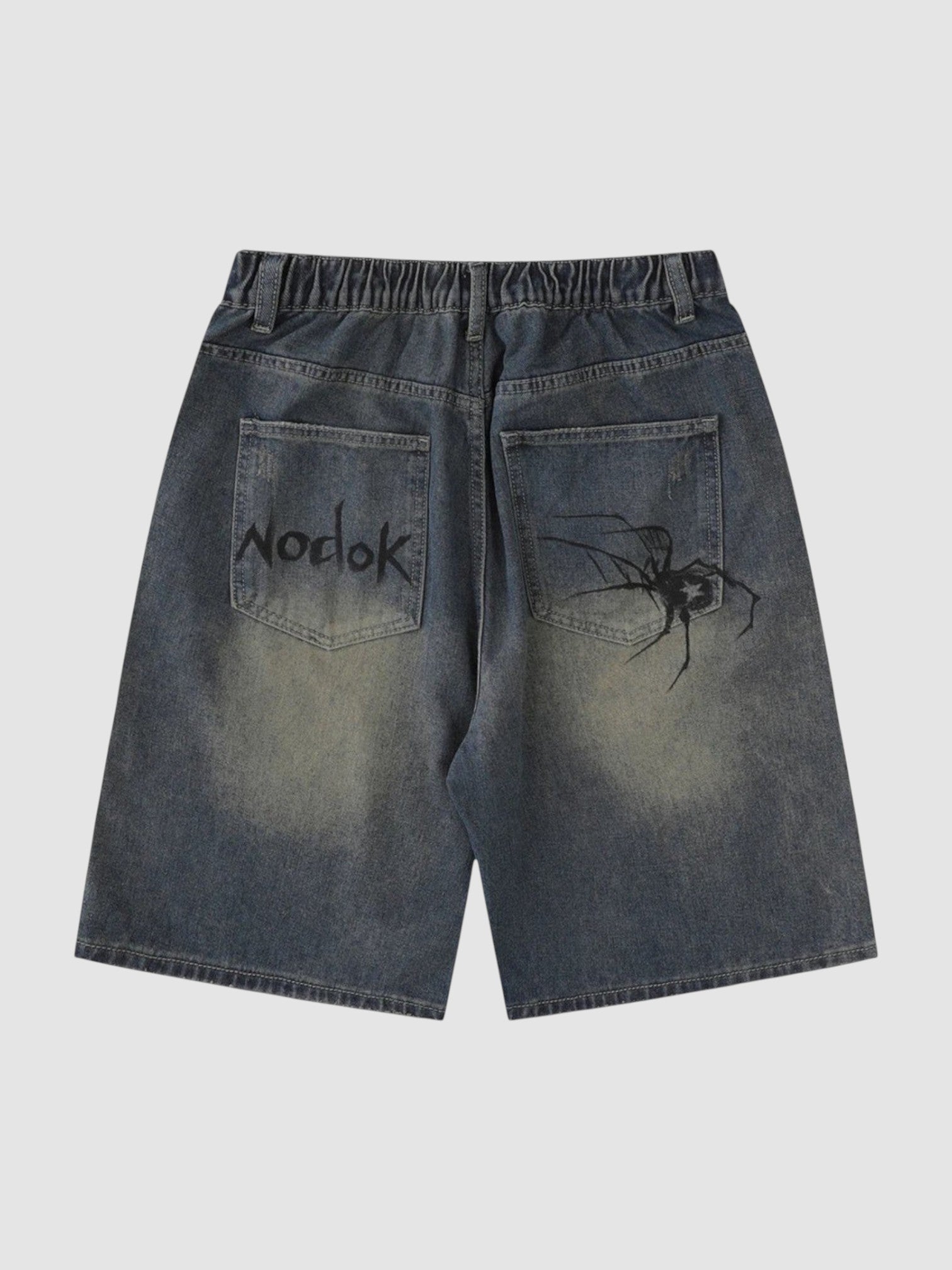 Y2K Studio blue denim jorts with spider graphic on the back pocket and graffiti style text on the other pocket