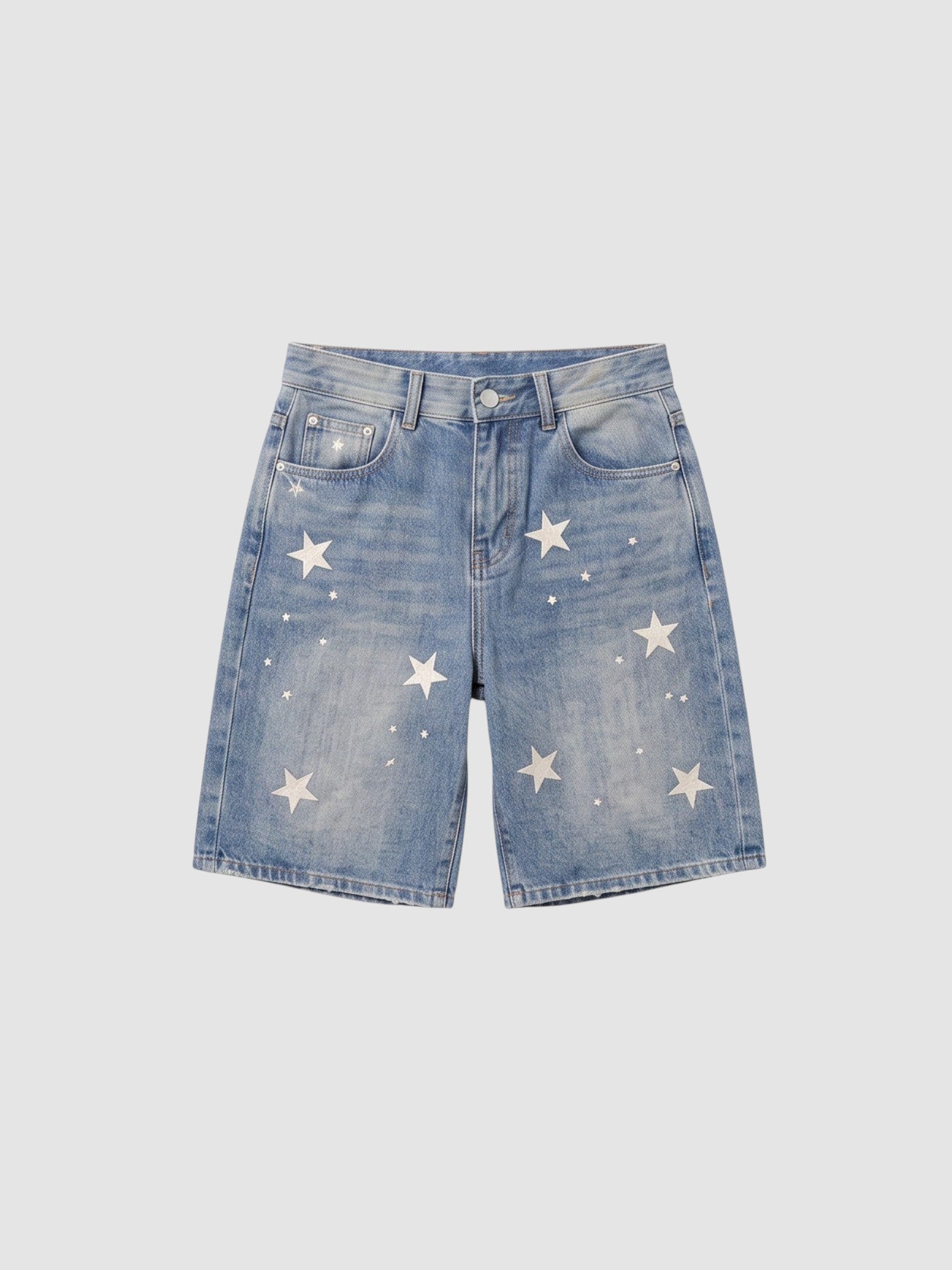 Y2K Studio high-waisted light blue denim jorts featuring scattered white star prints and a relaxed straight-leg fit.