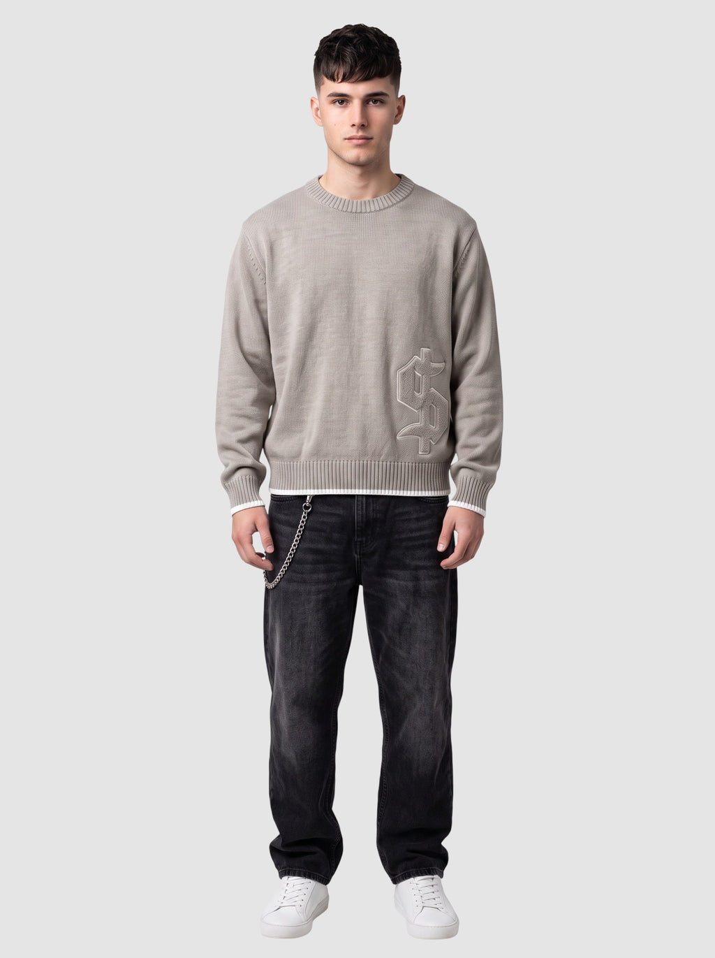 Y2K Studio taupe grey cotton knit sweater with gothic dollar patch, ribbed crew neck, and white trim details.