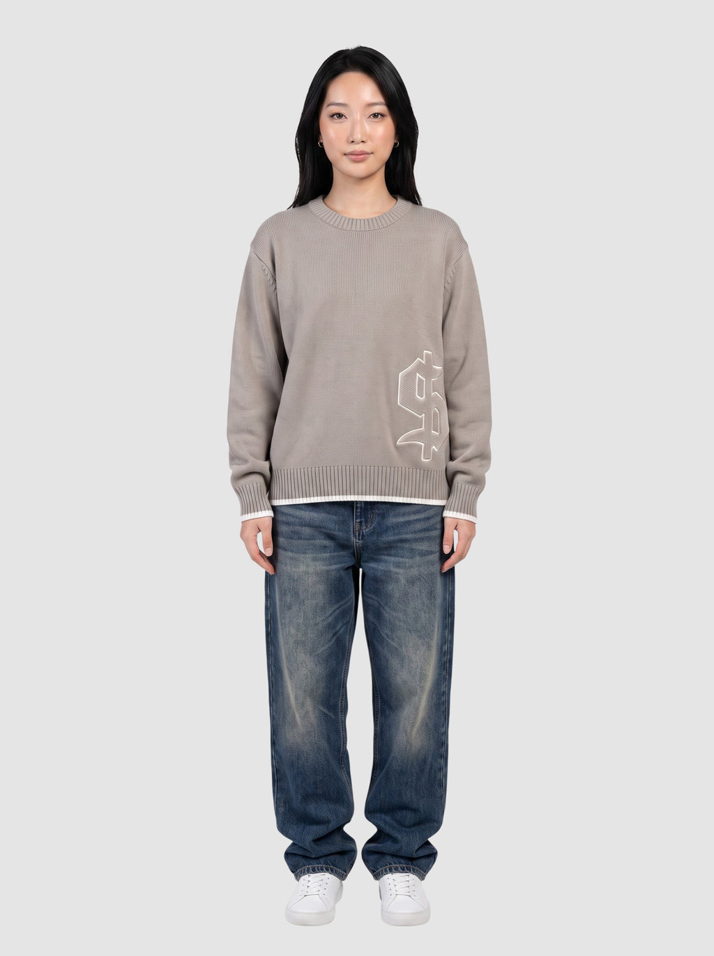 Y2K Studio taupe cotton knit sweater with gothic dollar patch, boxy fit, and white trim details on a model