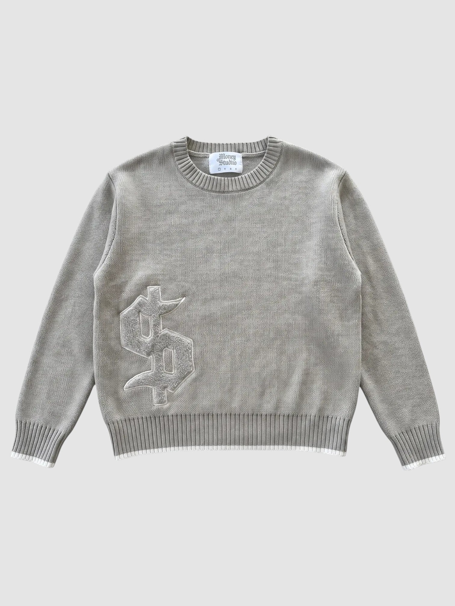 Y2K Studio taupe grey cotton knit sweater with a gothic dollar sign applique and white-tipped ribbed hem and cuffs.