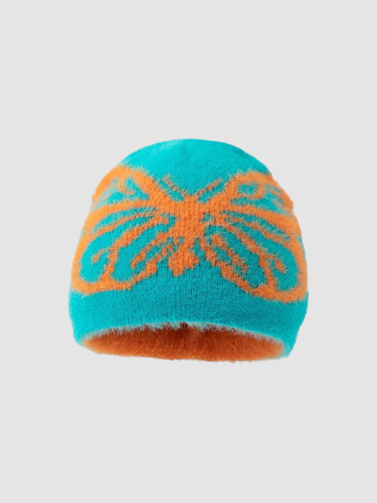 Y2K STUDIO fuzzy knit beanie in teal and orange with a prominent butterfly pattern for a casual winter look