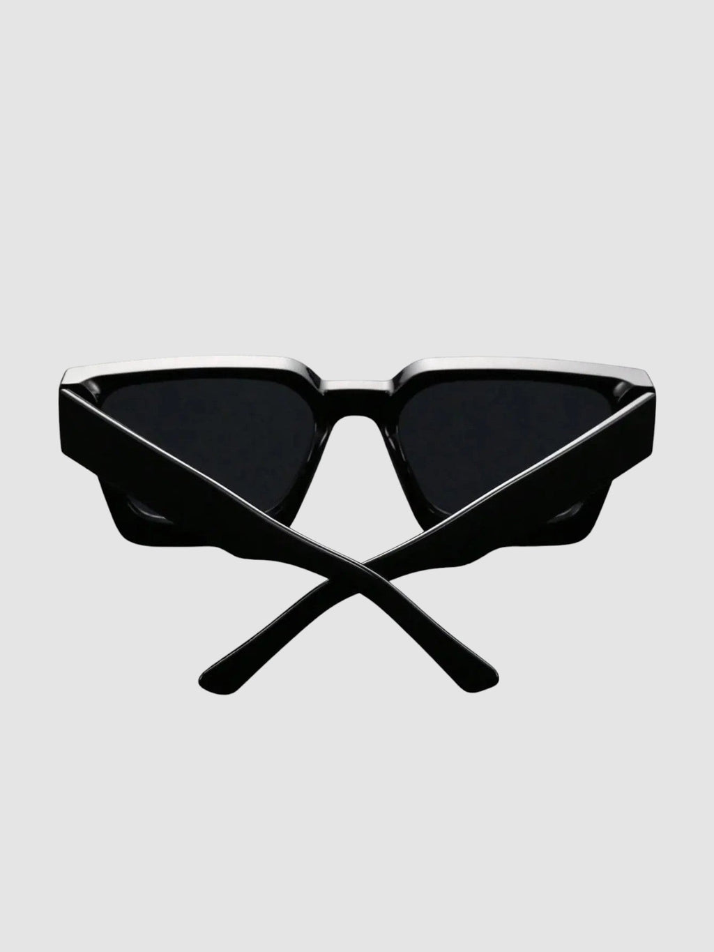 Y2K Studio thick black rectangular sunglasses with wide temples and UV400 polycarbonate lenses on a dark surface