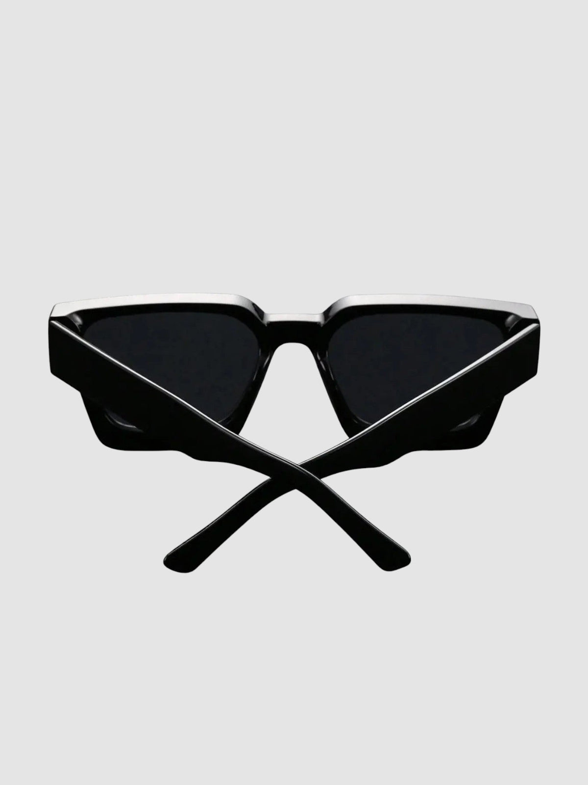Y2K Studio thick black rectangular sunglasses with wide temples and UV400 polycarbonate lenses on a dark surface
