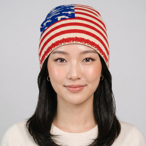 Y2K Studio USA flag beanie with stars and stripes pattern worn by a model on a light grey background
