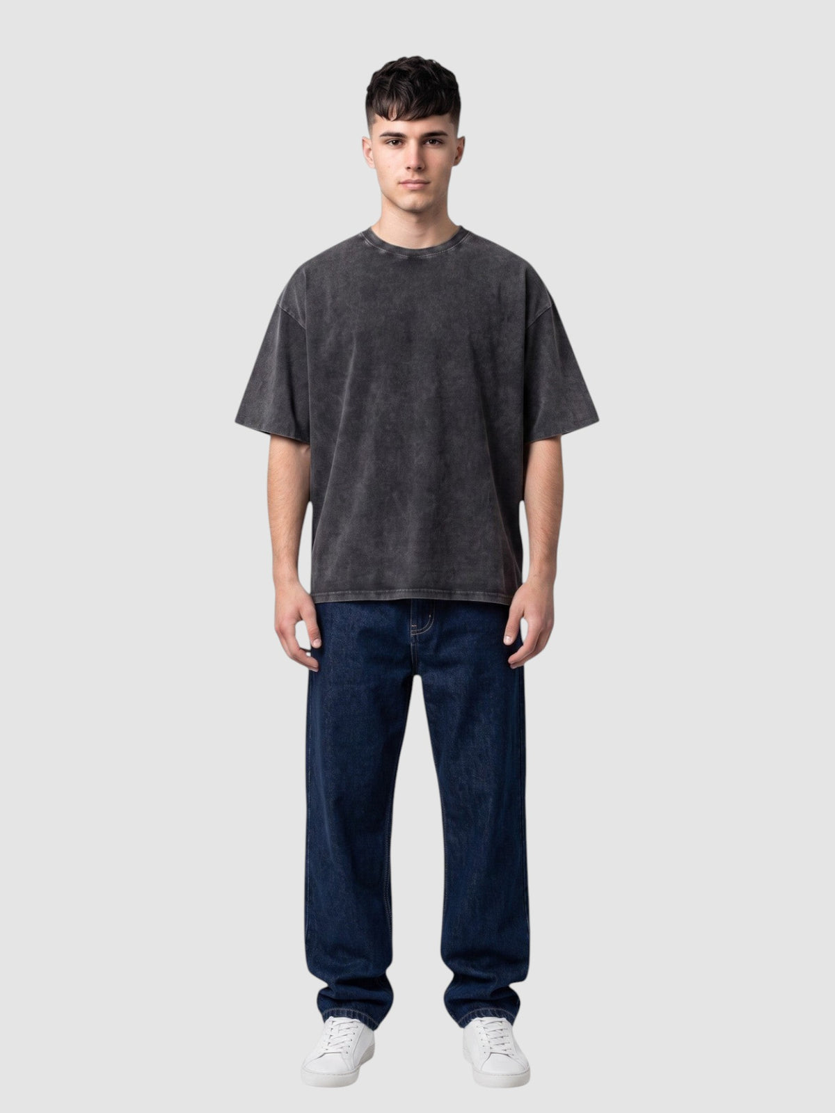 Y2K Studio vintage washed black cotton t-shirt with a relaxed fit, crew neck, and short sleeves on a male model.
