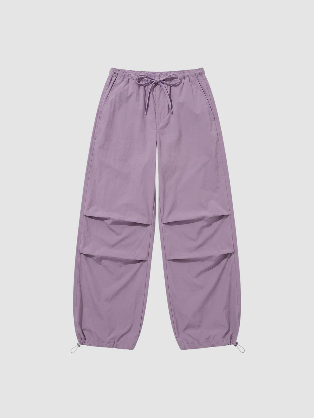 Y2K Studio high-waisted violet parachute pants in matte nylon with adjustable drawstring waist and ankle cuffs.