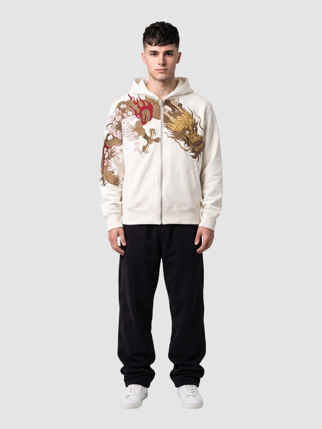 Y2K Studio white zip-up hoodie featuring a gold and red dragon and cherry blossom print, worn by a male model.