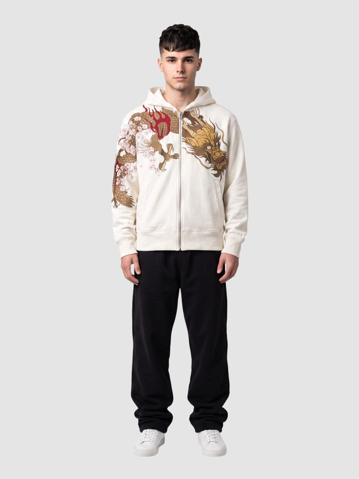 Y2K Studio white zip-up hoodie featuring a gold and red dragon and cherry blossom print, worn by a male model.