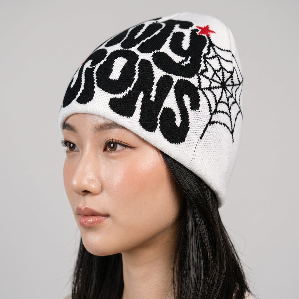 Y2K STUDIO white knit beanie with black graphic print and spiderweb design worn by a model
