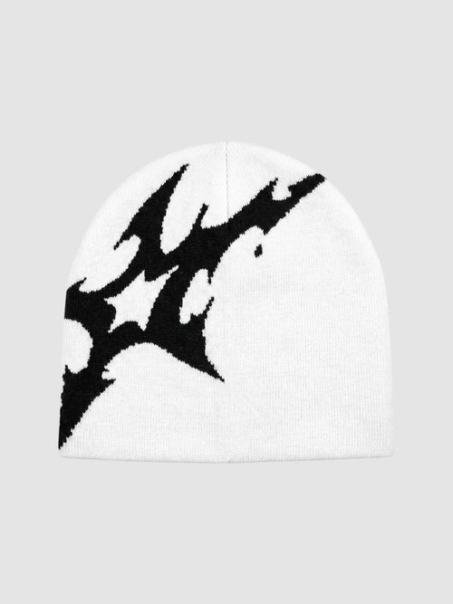 Y2K Studio white acrylic beanie featuring an asymmetrical black lightning bolt graphic pattern