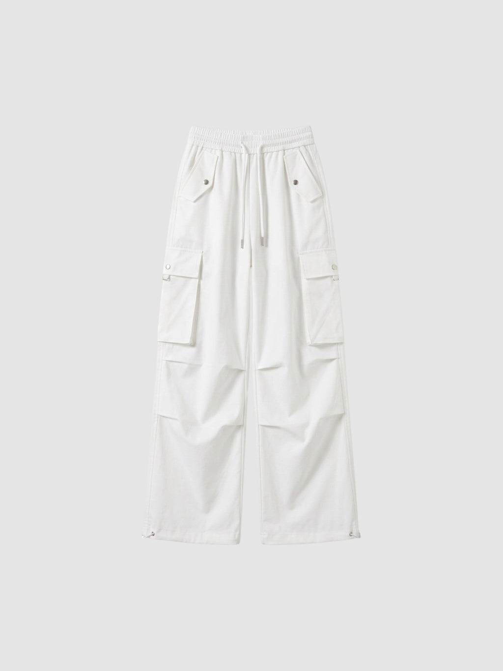 Y2K Studio white high-waisted parachute cargo pants in matte poplin with multiple pockets and adjustable leg cords.