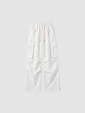 Y2K Studio white high-waisted parachute cargo pants in matte poplin with multiple pockets and adjustable leg cords.