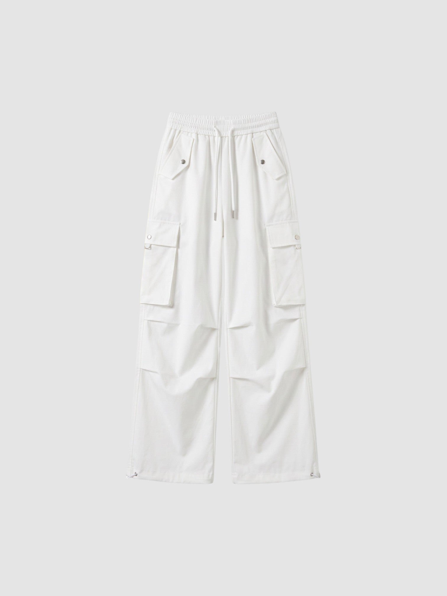Y2K Studio white high-waisted parachute cargo pants in matte poplin with multiple pockets and adjustable leg cords.