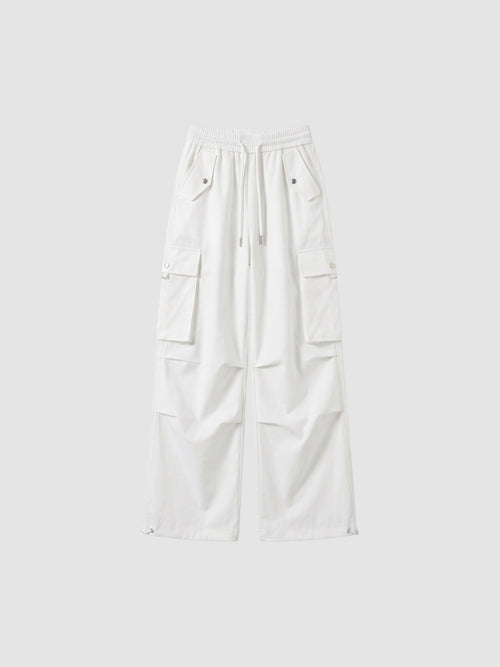 Y2K Studio white high-waisted parachute cargo pants in matte poplin with multiple pockets and adjustable leg cords.