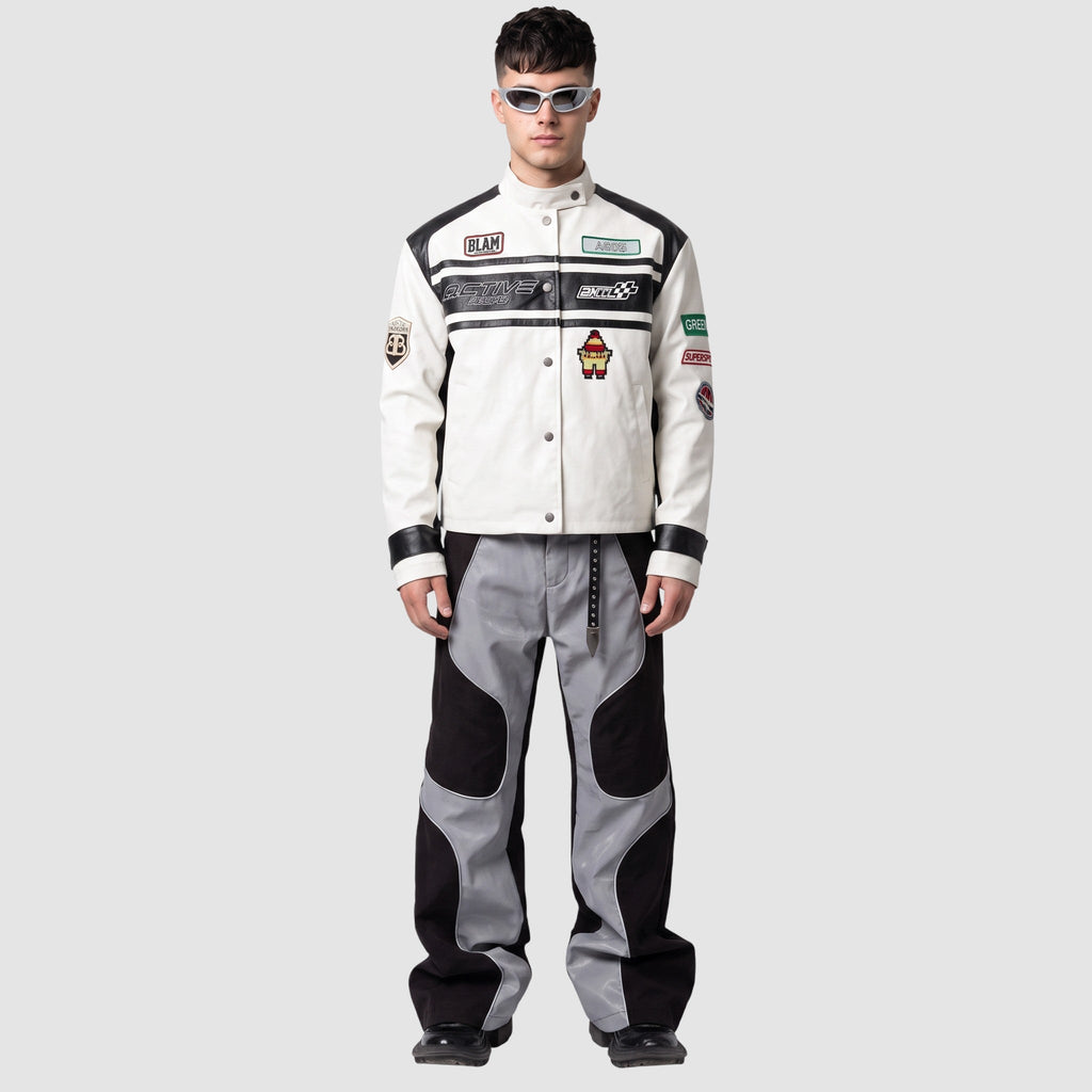 Y2K STUDIO wide leg faux leather pants with wavy grey and black panels and white piping worn by a male model